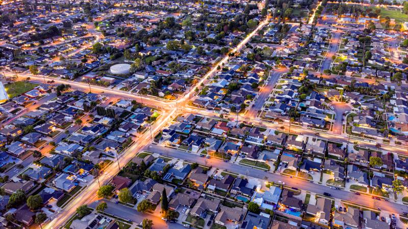 aerial shot of neighborhoods divided by lighted streets